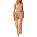 woman wearing wide leg jumpsuit with mid waist and round neckline shown in full front view outfit